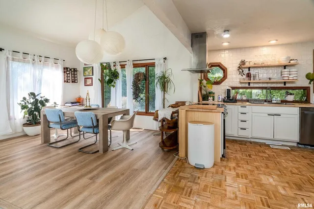 a kitchen with stainless steel appliances a stove a sink and a clock