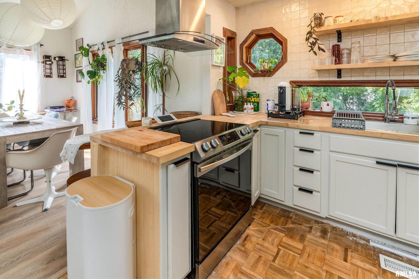 183 Heritage Road Carbondale, IL 62903 - Photo 13 of 50 a kitchen with stainless steel appliances granite countertop a sink a stove and a wooden floor