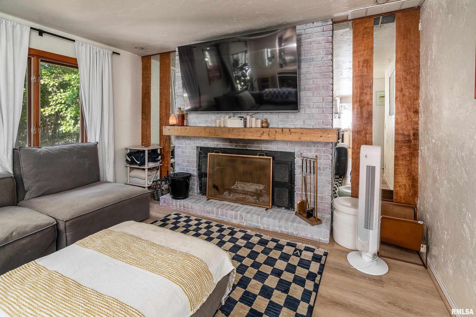 183 Heritage Road Carbondale, IL 62903 - Photo 19 of 50 a living room with furniture a fireplace and a flat screen tv