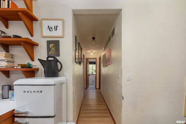 a bedroom with a bed and a painting on the wall