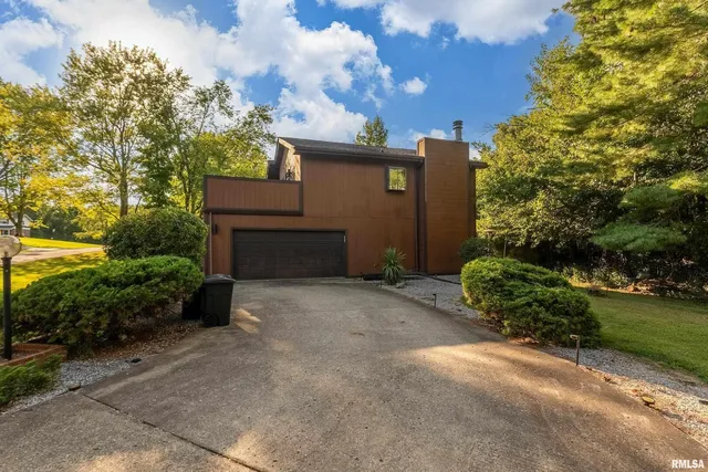a front view of a house with a yard table and chairs