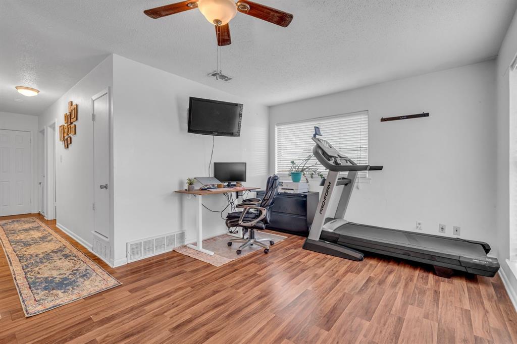 3800 Redstone Road Denton, TX 76209 - Photo 13 of 33 a view of a workspace with furniture and a ceiling fan