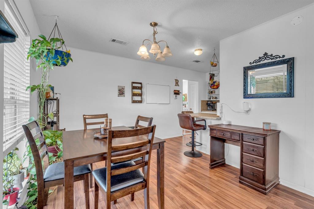 3800 Redstone Road Denton, TX 76209 - Photo 17 of 33 a view of a dining room with furniture and wooden floor