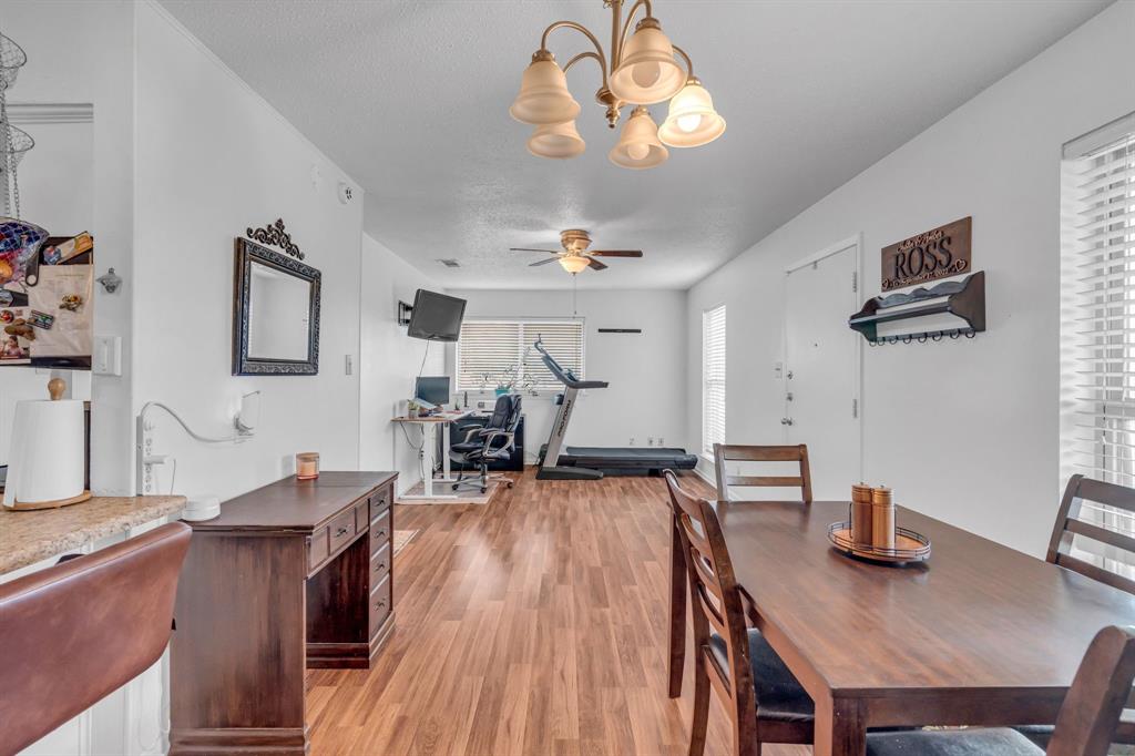3800 Redstone Road Denton, TX 76209 - Photo 18 of 33 a view of a dining room with furniture wooden floor and chandelier
