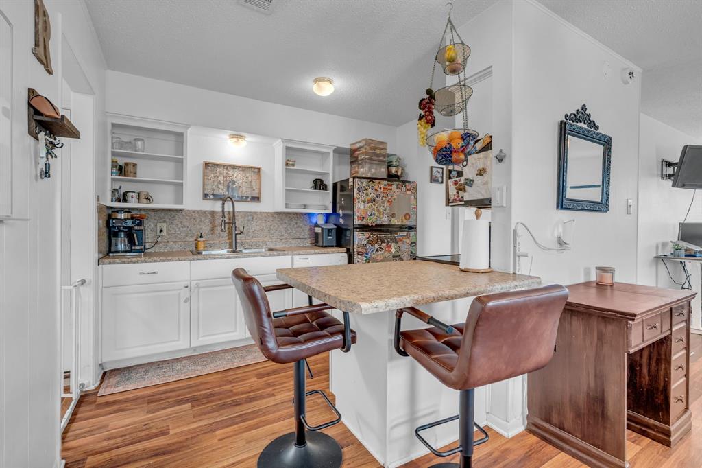 3800 Redstone Road Denton, TX 76209 - Photo 19 of 33 a dinning room with kitchen island furniture a chandelier and kitchen view