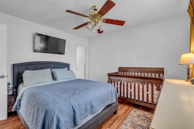 a bedroom with a bed and a chandelier