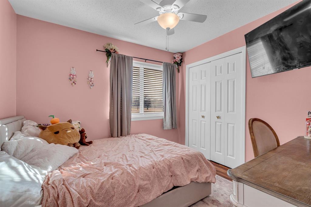 3800 Redstone Road Denton, TX 76209 - Photo 29 of 33 a bedroom with a bed and a chandelier