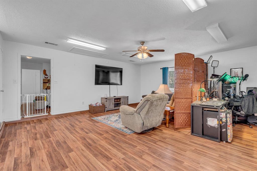 3800 Redstone Road Denton, TX 76209 - Photo 8 of 33 a living room with furniture and a flat screen tv