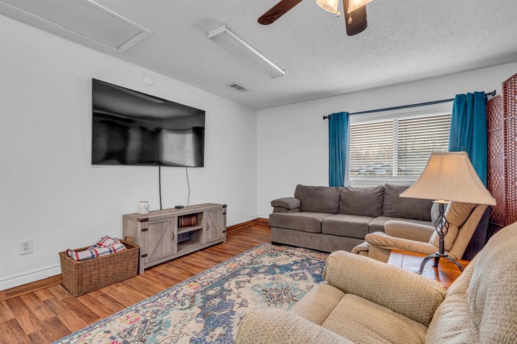3800 Redstone Road Denton, TX 76209 - Photo 9 of 33 a living room with furniture and a flat screen tv