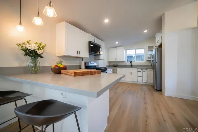 a kitchen with a sink cabinets and window