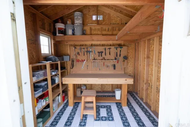 a living room with furniture a fireplace and a chandelier