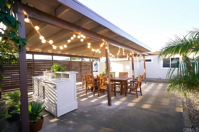 a view of a patio with dining table and chairs