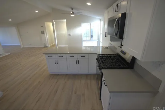 a kitchen with a sink stainless steel appliances and cabinets