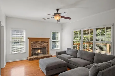 a living room with furniture a window and a fireplace