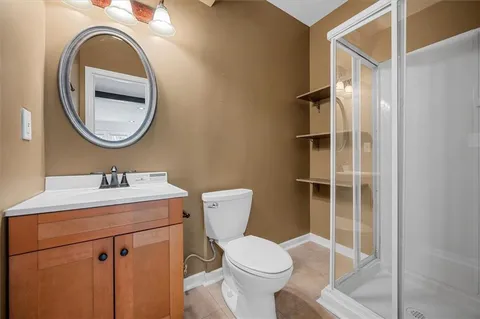 a bathroom with a toilet a sink and a mirror