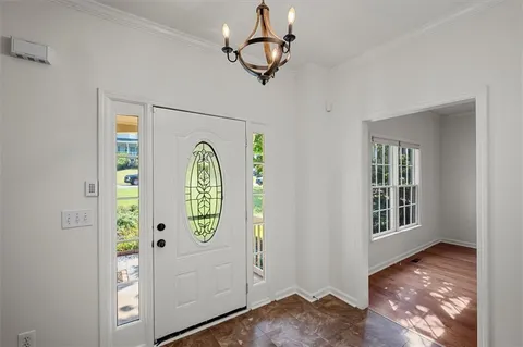 a view of an entryway with wooden floor