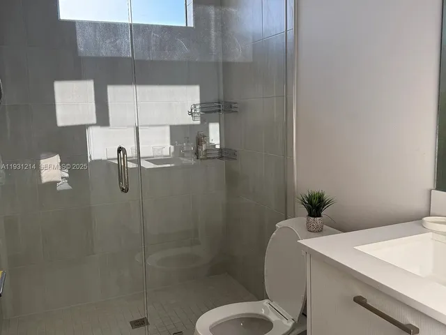 a white toilet sitting next to a shower curtain