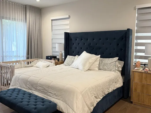 a bedroom with bed and window