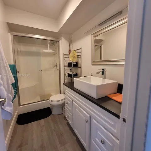 a bathroom with a double vanity sink toilet and shower