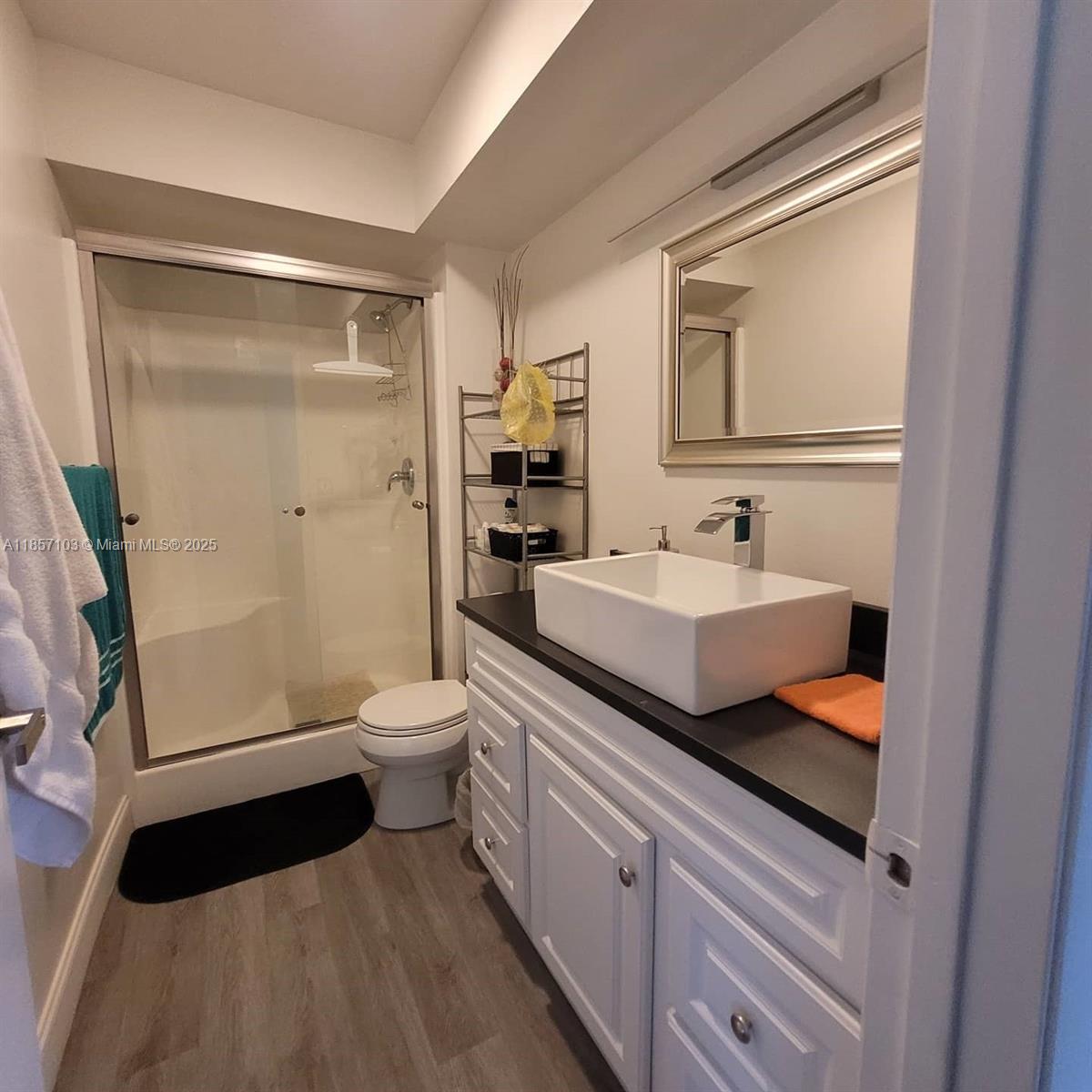 4375 White Pine Avenue, Unit 824 Orlando, FL 32811 - Photo 11 of 12 a bathroom with a double vanity sink toilet and shower
