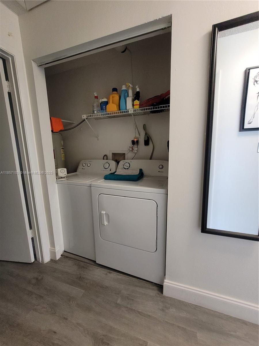 4375 White Pine Avenue, Unit 824 Orlando, FL 32811 - Photo 12 of 12 a utility room with wooden floor washer and dryer
