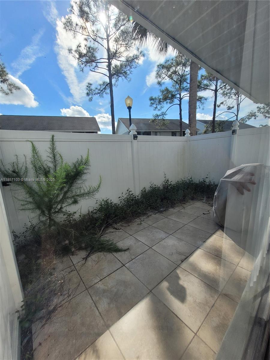 4375 White Pine Avenue, Unit 824 Orlando, FL 32811 - Photo 2 of 12 a view of a backyard with plants and large trees