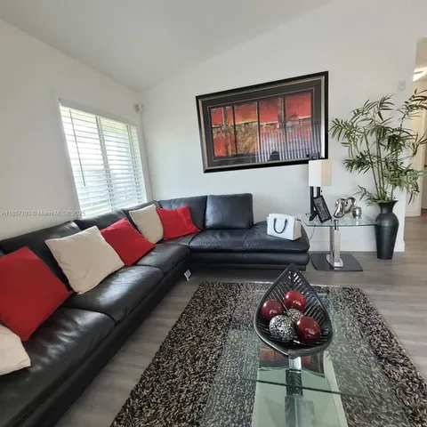 a living room with furniture and a rug