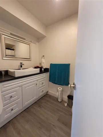 a spacious bathroom with a sink and a mirror