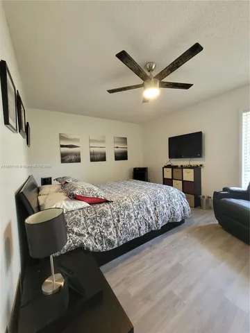 a bedroom with a bed and a couch