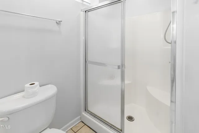 a bathroom with a shower and toilet