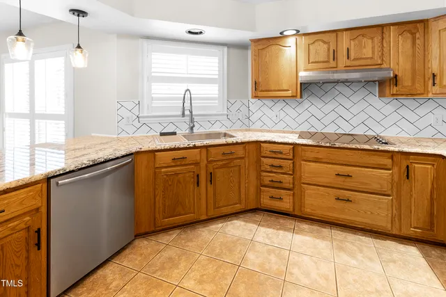 a kitchen with a sink window and cabinets