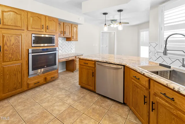 a kitchen with stainless steel appliances granite countertop a sink and cabinets