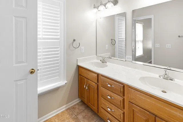 a bathroom with a double vanity sink a and a mirror