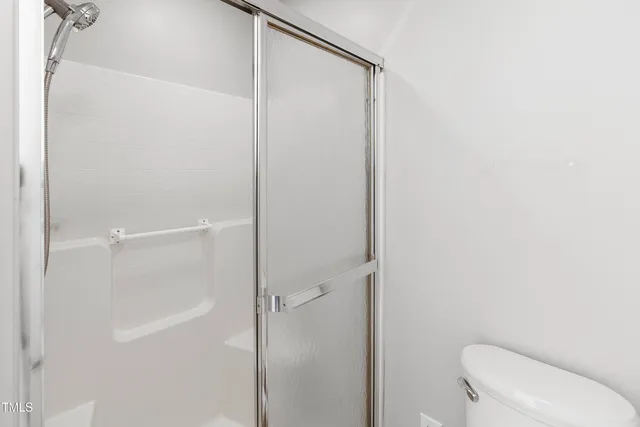 a bathroom with a shower and a toilet