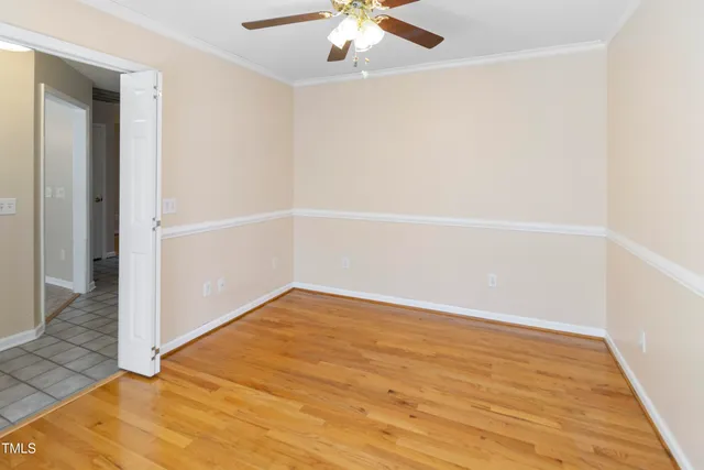 an empty room with a windows and ceiling fan