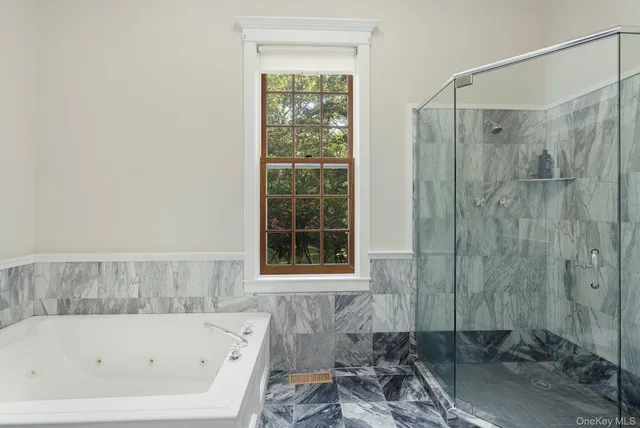 a bathroom with a bathtub and a shower