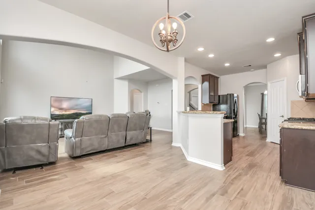 a living room with furniture and kitchen view