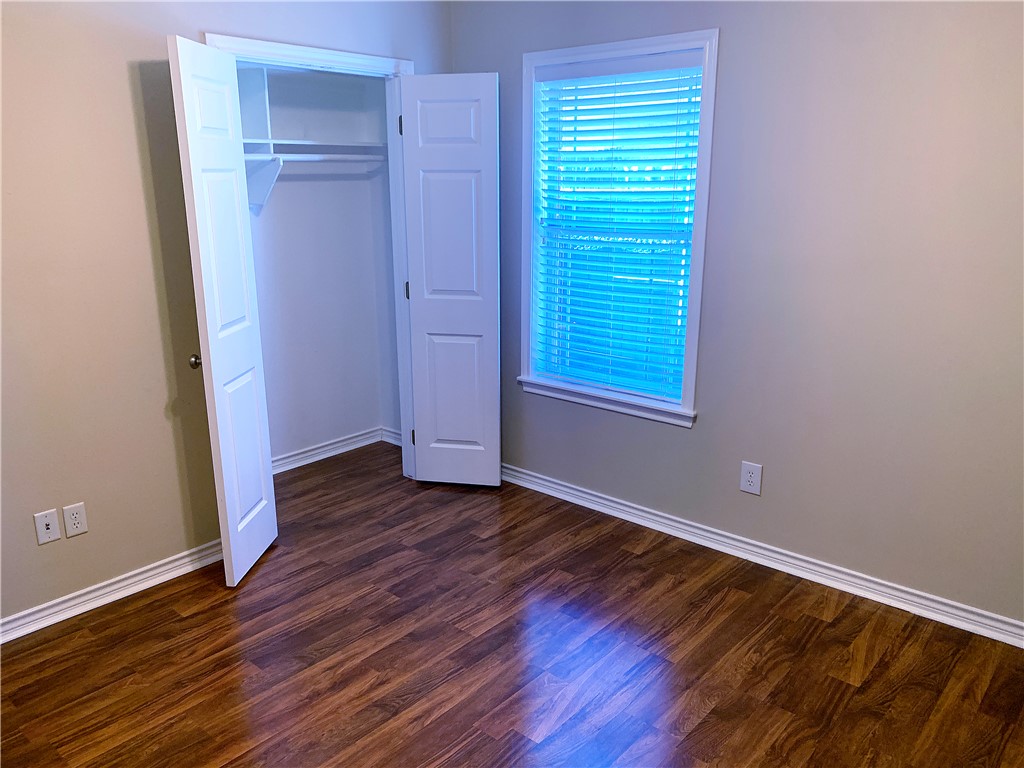 105 Karten Lane College Station, TX 77845 - Photo 11 of 26 an empty room with wooden floor and windows