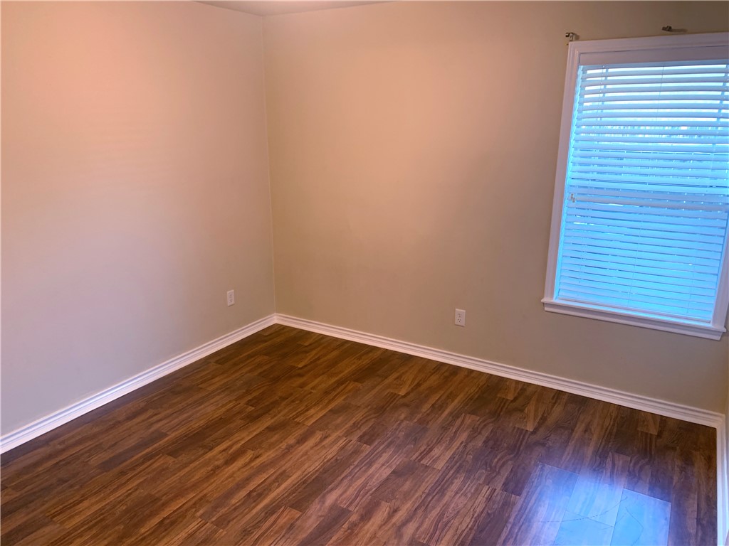 105 Karten Lane College Station, TX 77845 - Photo 14 of 26 a view of an empty room with wooden floor and a window