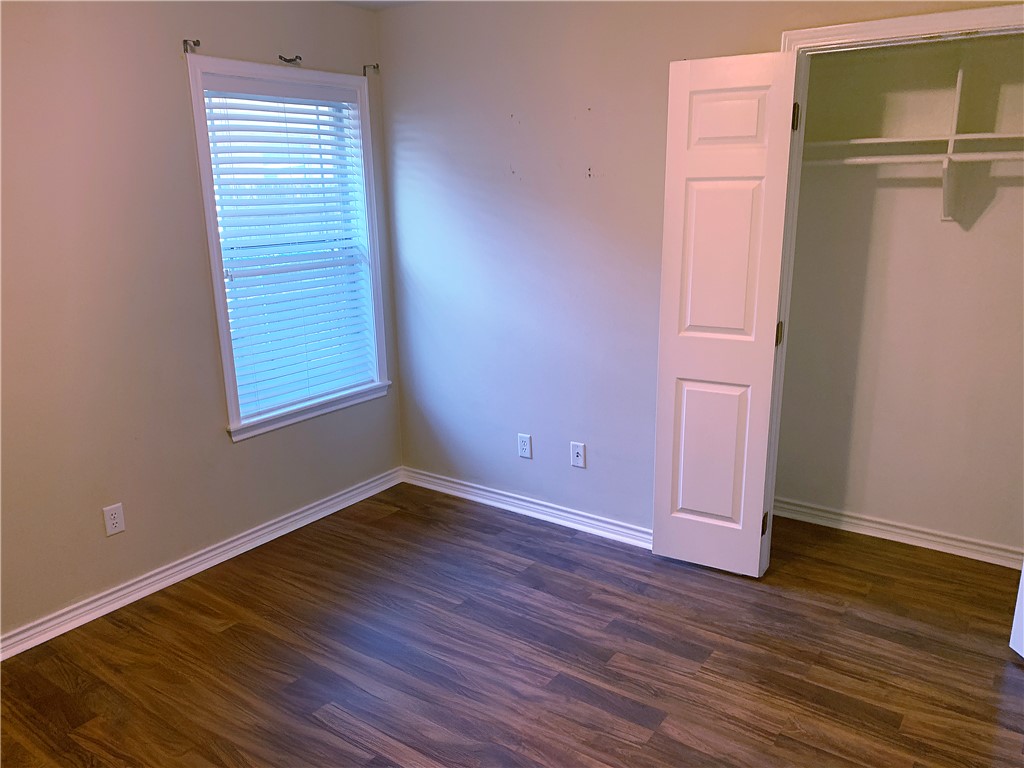 105 Karten Lane College Station, TX 77845 - Photo 16 of 26 an empty room with wooden floor closet and windows