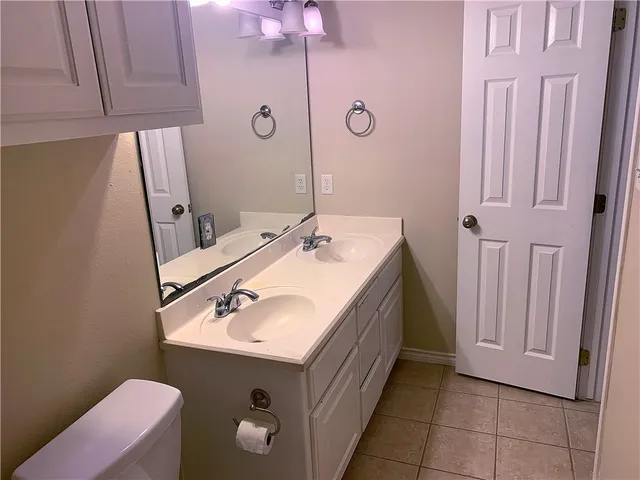 a bathroom with a sink vanity and mirror