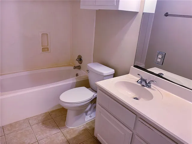 a bathroom with a sink a toilet and bathtub