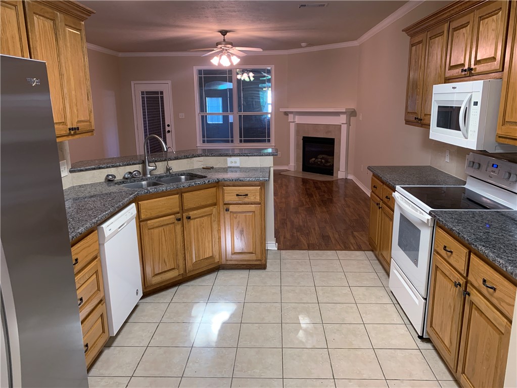 105 Karten Lane College Station, TX 77845 - Photo 6 of 26 a large kitchen with granite countertop a stove a sink and a microwave
