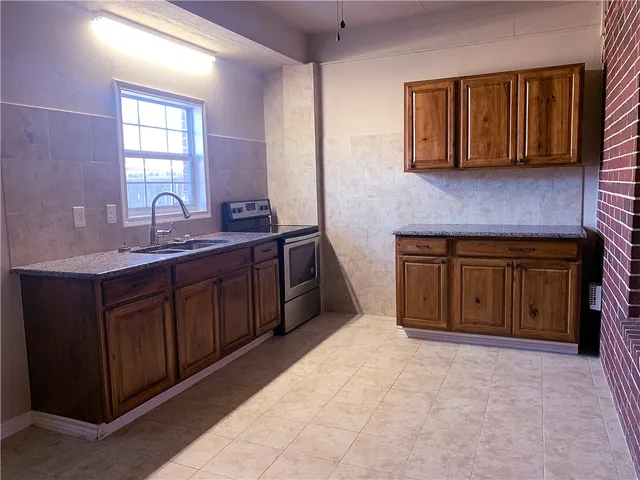 a spacious bathroom with a sink and a mirror