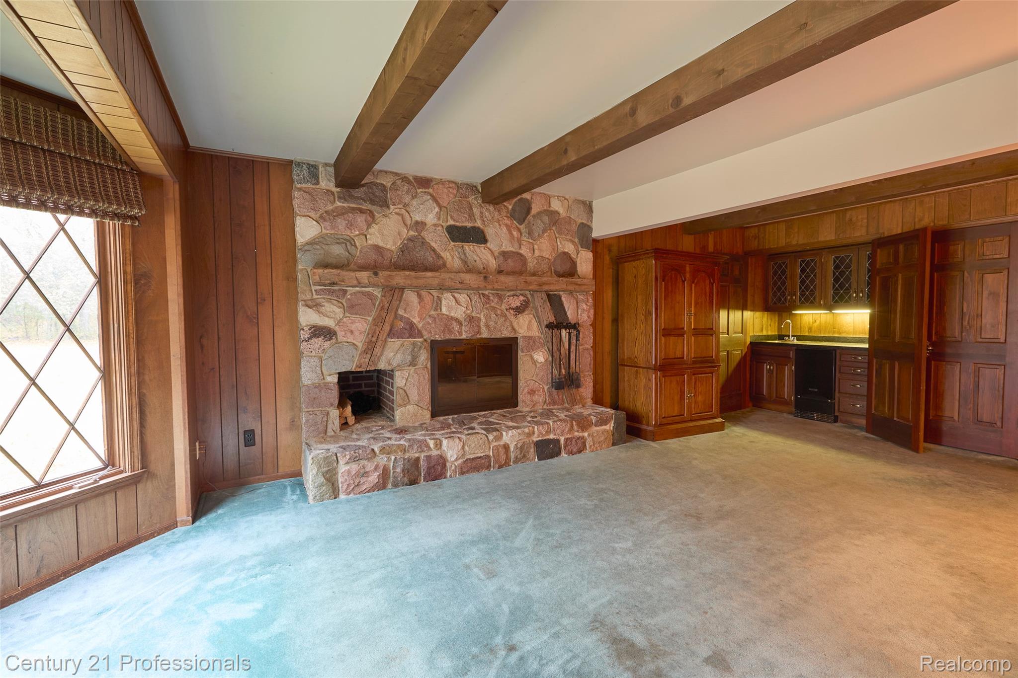 303 East Snell Road Rochester, MI 48306 - Photo 13 of 45 custom stone fireplace and beamed ceiling with wet bar