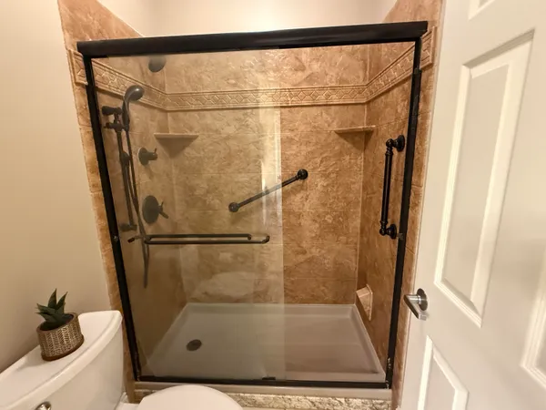 a bathroom with a glass shower door
