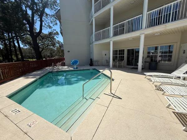 a view of a house with a backyard and a chair