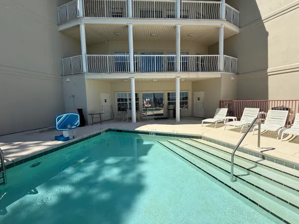a view of swimming pool with a table and chairs