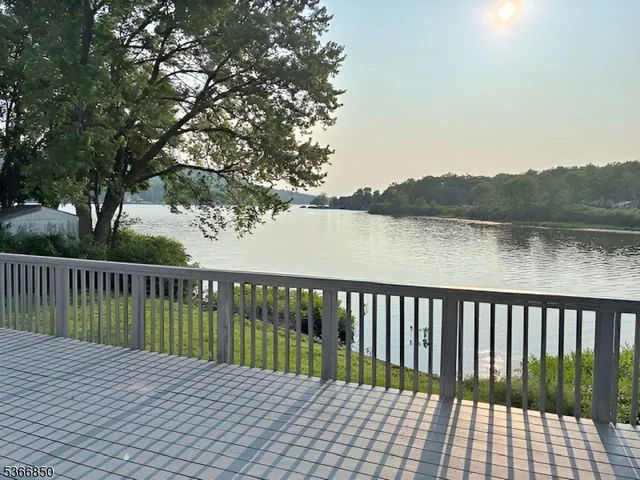 a view of balcony with wooden floor and lake view