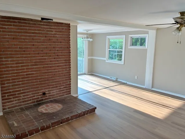 a view of a livingroom with an empty space and a window